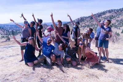 Group of people pointing toward the sky